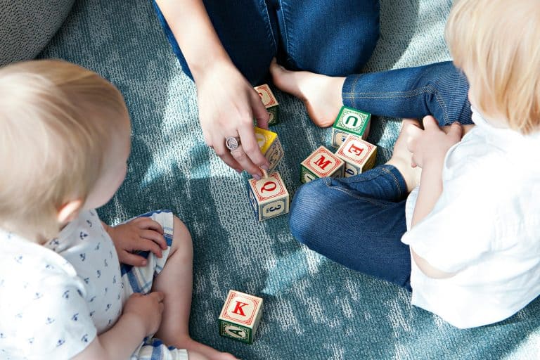 Mom and kids with alphabet blocks