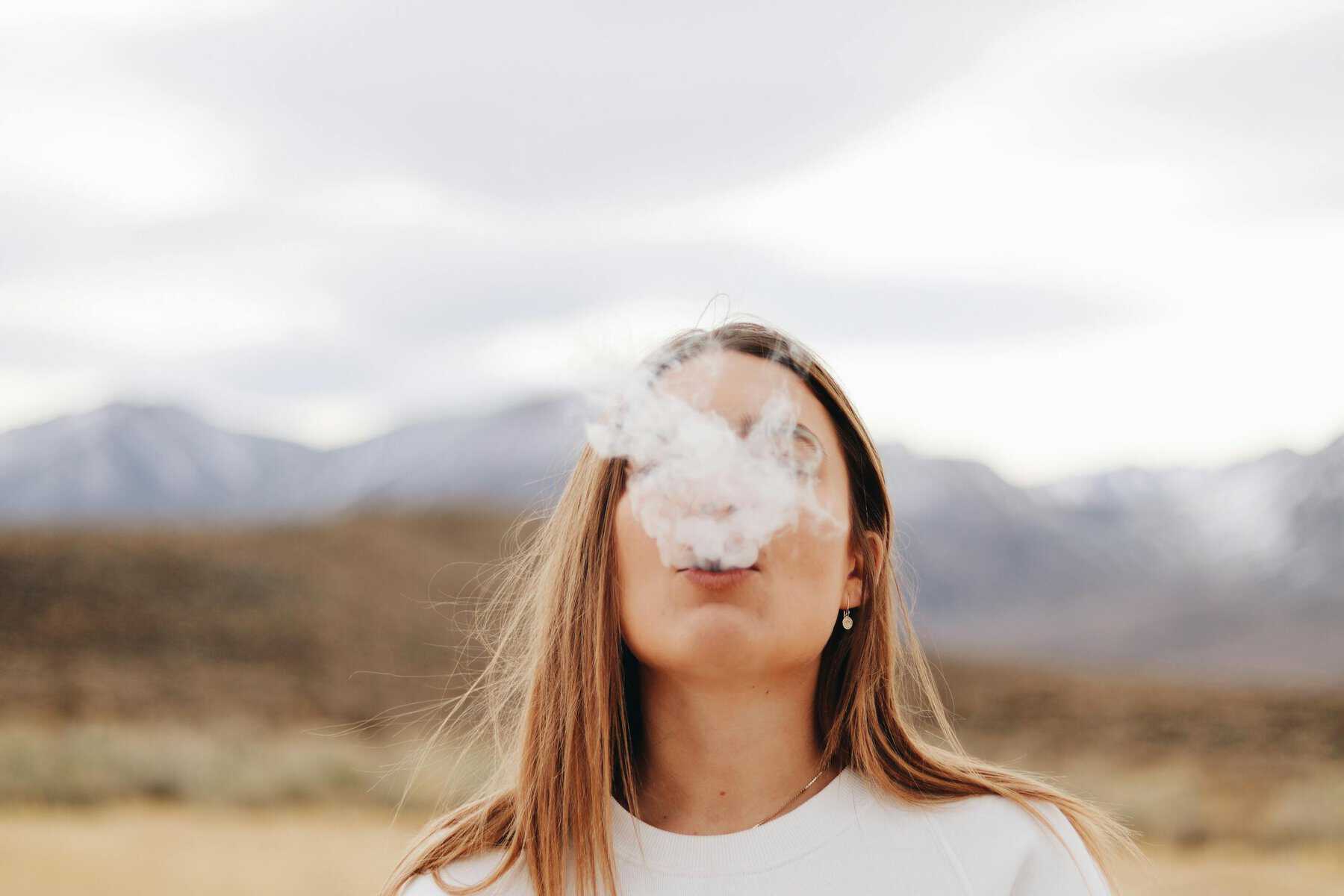 Woman smoking Wearing White Crew-neck Shirt